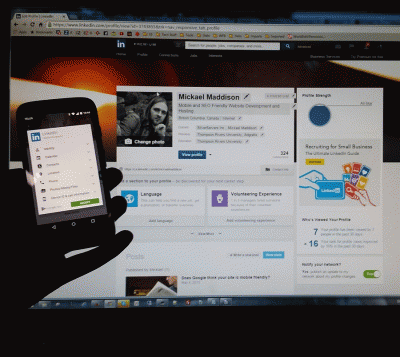 A LinkedIn profile open on a desktop monitor and in the LinkedIn app on a phone